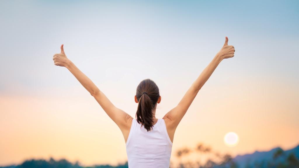 happy and healthy woman doing thumbs up