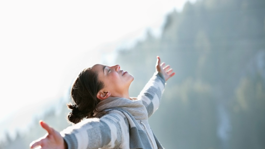 woman with head back and arms outstretched